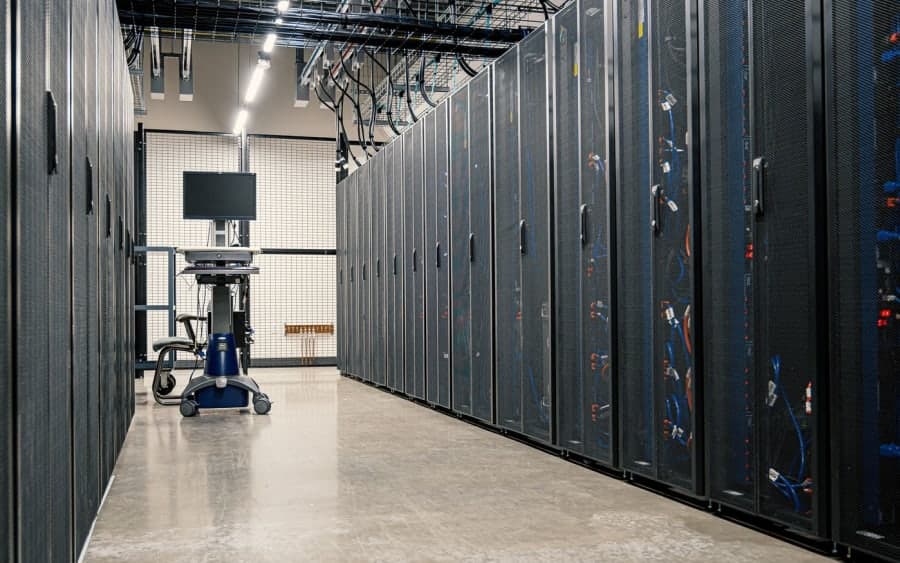 Rows of server racks in a data centre aisle.